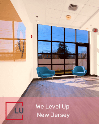 The photo displayed shows a seating area within We Level Up, a substance abuse treatment facility near Rochester, New York.