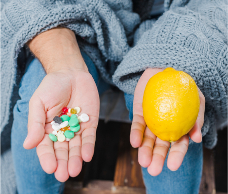 a person holding pills and lemon