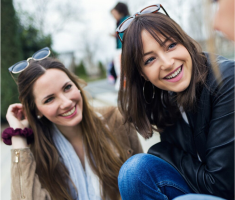 Two girls smiling and wondering - Is Gen Z the Loneliest Generation?